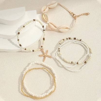 Set de 7 pulseras apilables con estrella de mar – Joyería artesanal de playa con mini cuentas para mujer