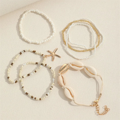 Set de 7 pulseras apilables con estrella de mar – Joyería artesanal de playa con mini cuentas para mujer